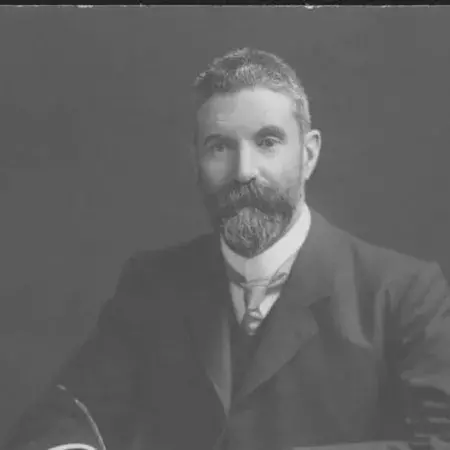 Portrait of Alfred Deakin sitting at a desk