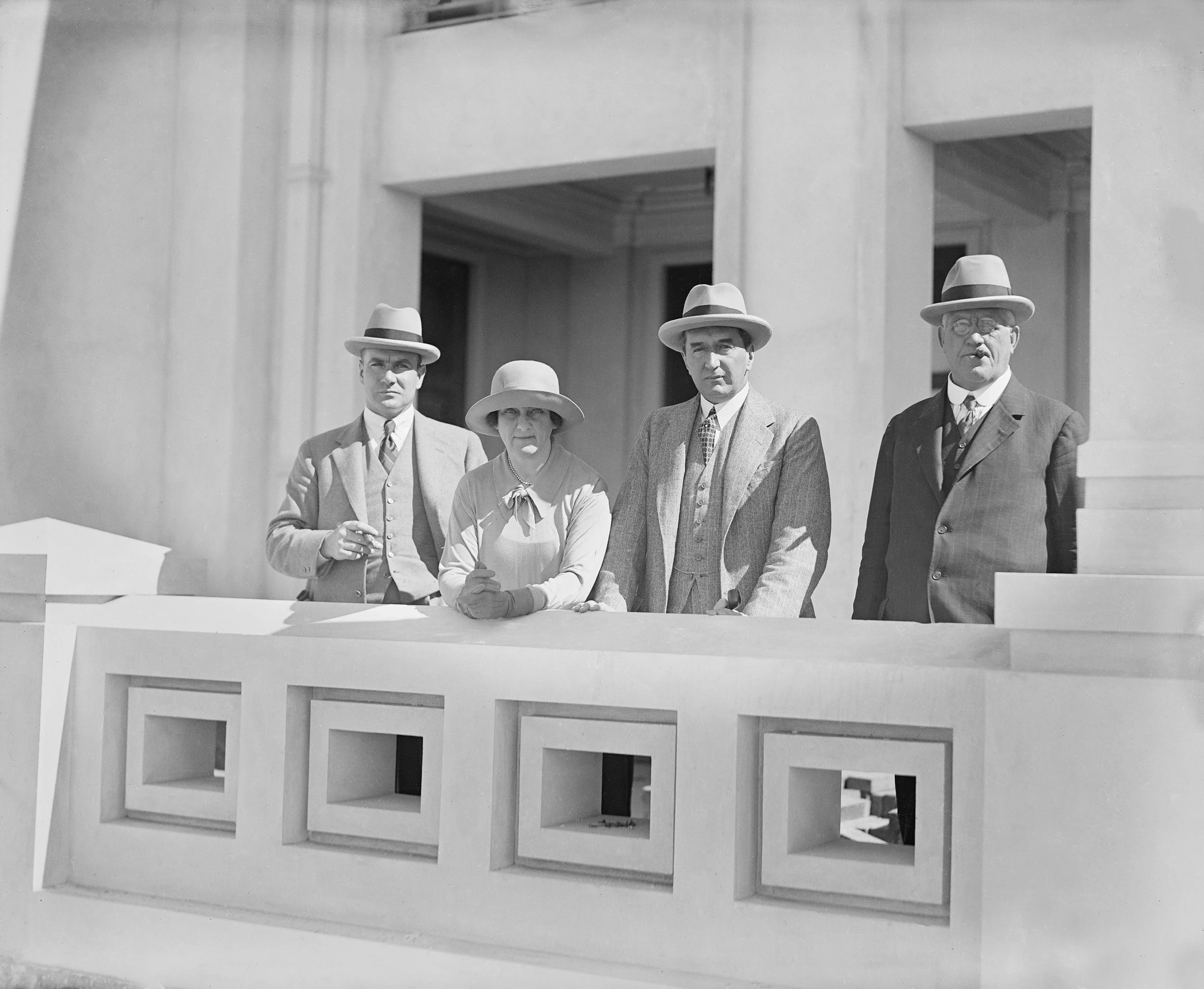 Stanley Bruce and his wife stand on the construction site of Old Parliament House.  