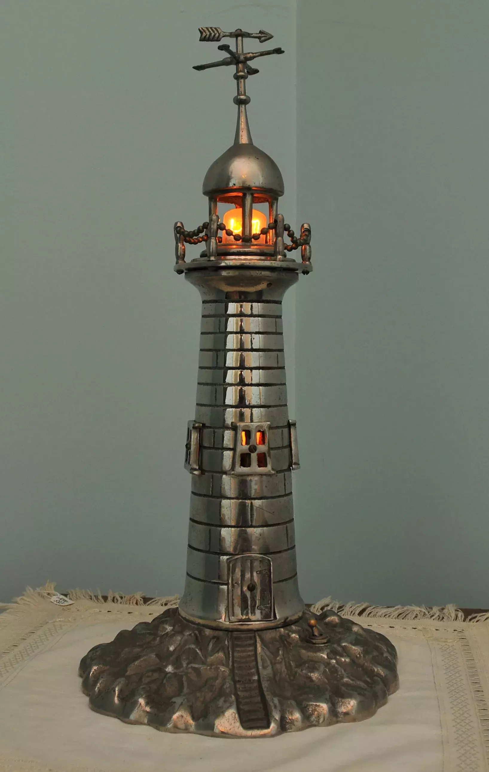 A metallic model lighthouse
