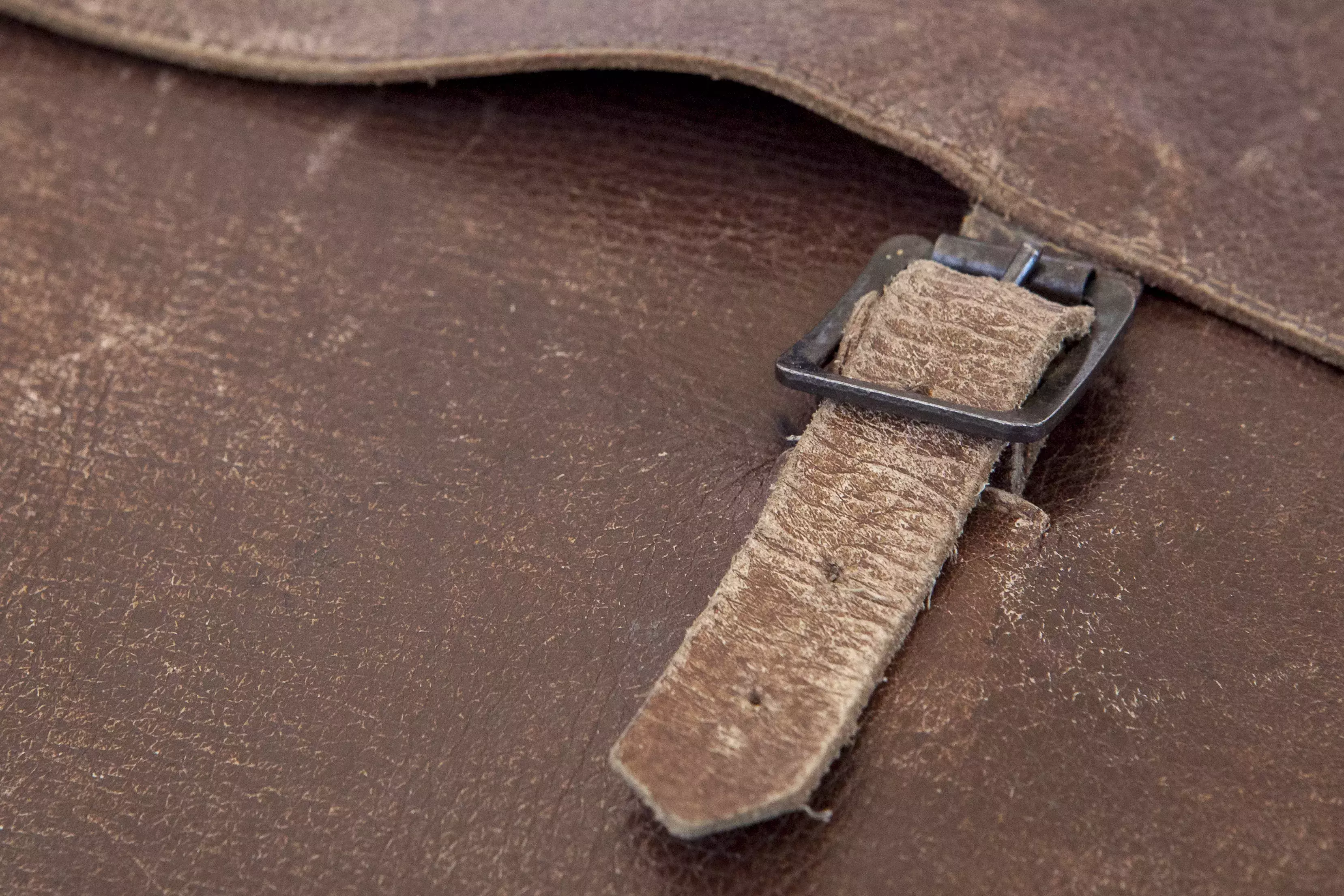 Close up of buckle on leather satchel 