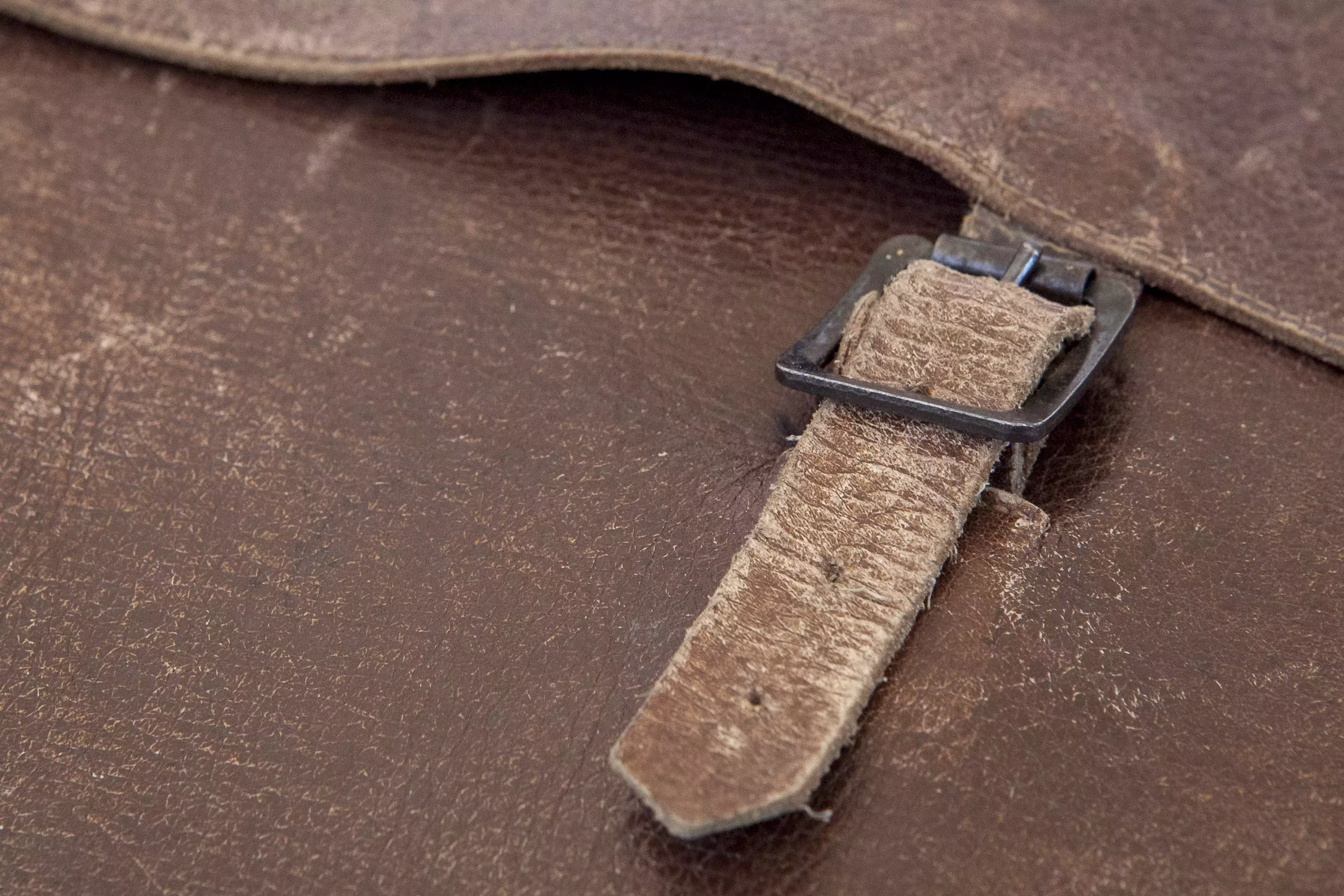 Close up of buckle on leather satchel